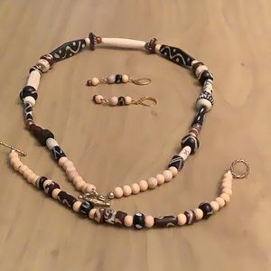 Necklace is 21 and 3/4 inches long. Various wood and cow bones were used.